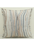 Chunky ivory cushion cover with flowy lines in warm brown, blue, and pink tones, perfect for home decor.