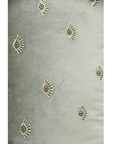 Hand-embroidered evil eye cushion cover on mint green velvet, featuring beads and sequins for elegance and protection.
