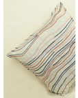 Chunky ivory cushion cover with embroidered flowy lines in warm tones for stylish home decor.