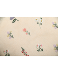 Tea Rose cushion featuring delicate floral embroidery in pink, lavender, and peach on a cream background.