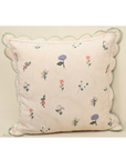 Tea Rose cushion featuring delicate floral motifs in lavender and peach with scalloped edging for elegant home decor.