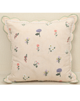 Tea Rose cushion with pink floral motifs in lavender and peach, featuring scalloped edging for elegant home decor.