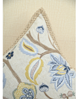 Vine cushion featuring intricate embroidery with colorful flowers and jute trim, enhancing cozy home decor.