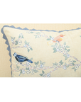 Hummingbirds cushion cover with intricate embroidery on cotton, featuring birds on branches and blue lace accents.