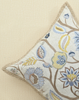 Decorative cushion with floral embroidery and intricate detailing, ideal for adding charm to any living space.