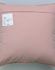 Pink pillow with a label on a gray background