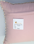 Pink fabric swatch with a label on a light gray background