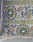 Decorative pillow with intricate floral and geometric patterns on a plain background