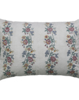 Decorative pillow with floral embroidery and green ruffles on a white background