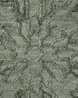 Close-up of Persian motifs on olive hand tufted wool rug