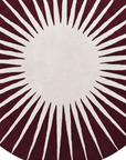 Close-up of Solara Ray handcrafted wool rug with radiating sunburst pattern