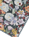 Floral patterned rug with colorful flowers on a dark background