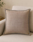 Sahara Weave beige cotton cushion cover with contrast piping on sofa