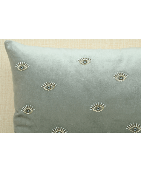 Hand-embroidered evil eye cushion cover in mint green velvet, featuring beads and sequins for elegance and protection.