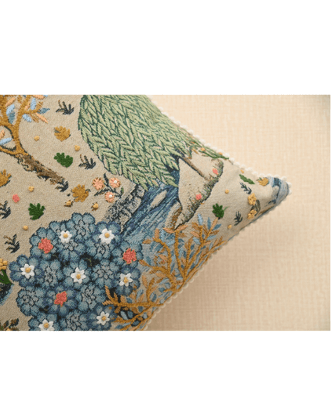 Bough cushion with intricate tree and floral print, accented with French knots in mustard, enhancing home décor.