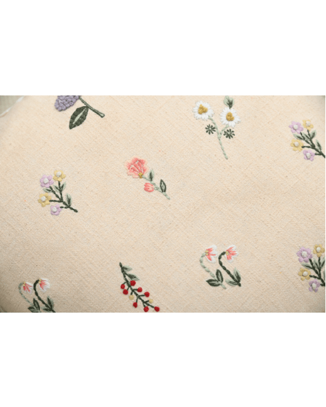 Tea Rose cushion featuring delicate floral embroidery in pink, lavender, and peach on a cream background.