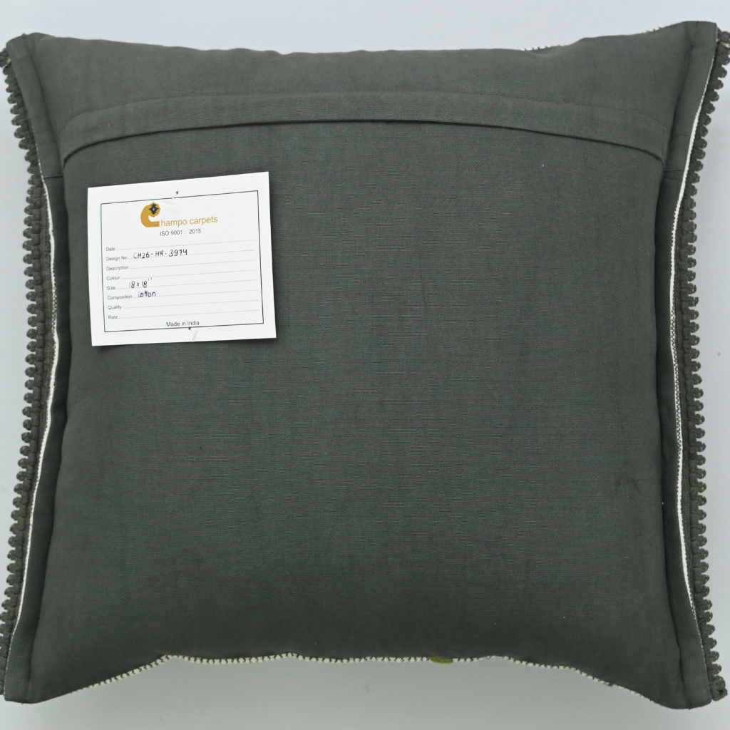 Dark gray pillow with a label on a light gray background