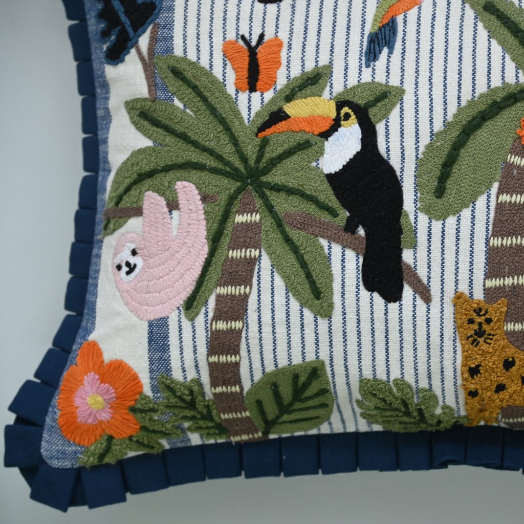 Decorative pillow with tropical animals and plants on a striped background