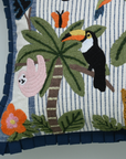 Decorative pillow with tropical animals and plants on a striped background