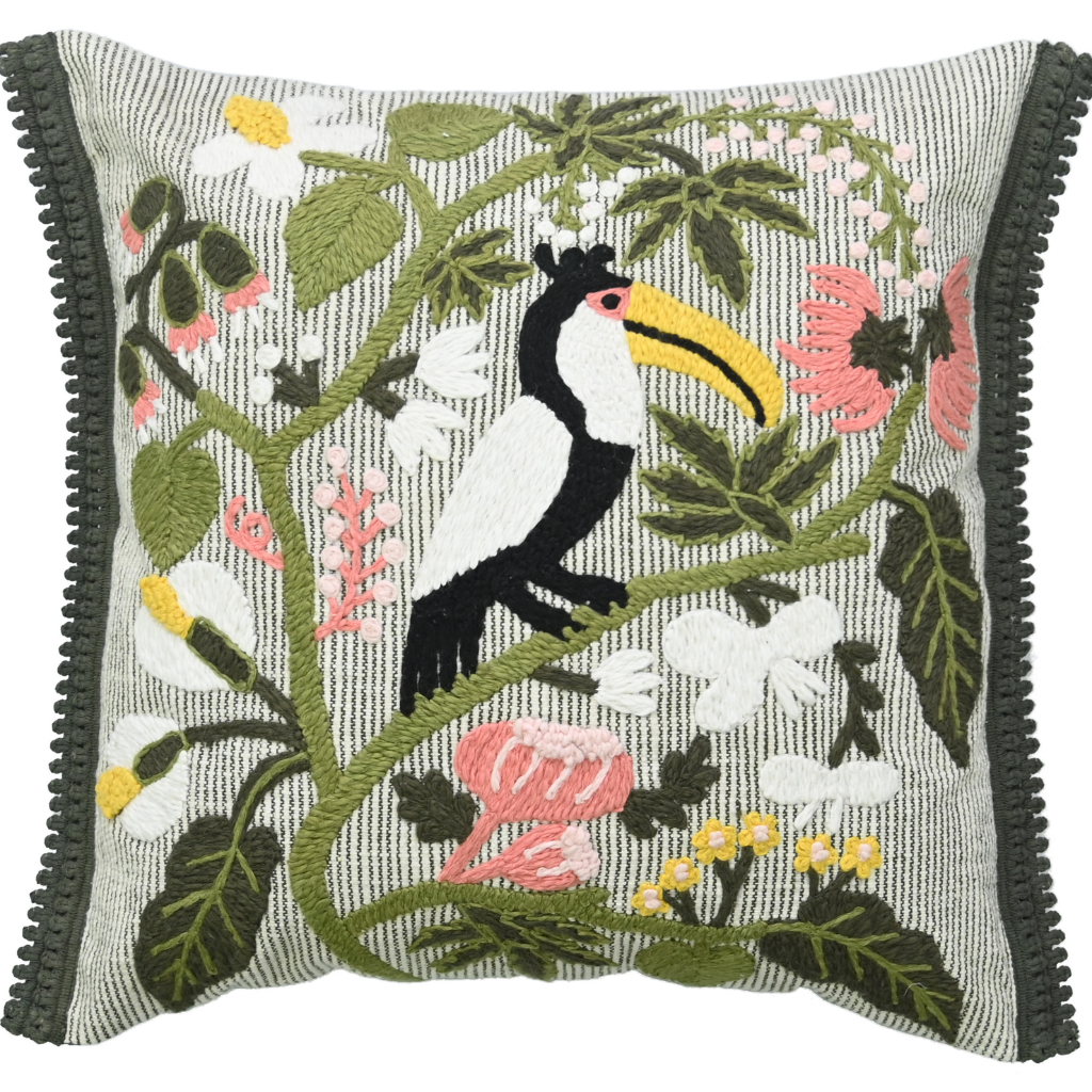 Embroidered pillow with a toucan and floral design on a white background