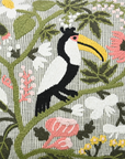 Embroidered toucan on a branch with flowers and leaves