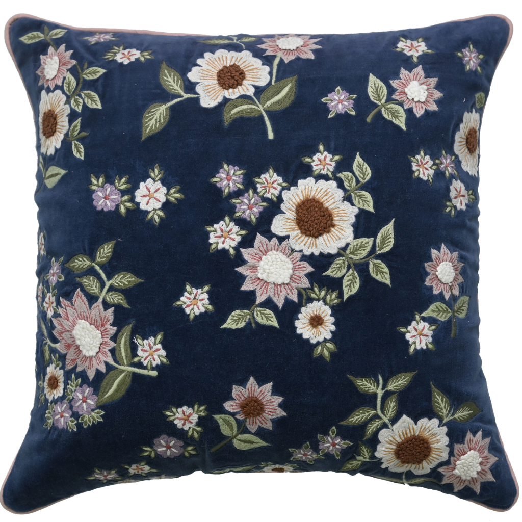 Floral embroidered pillow on a navy background