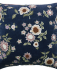 Floral embroidered pillow on a navy background