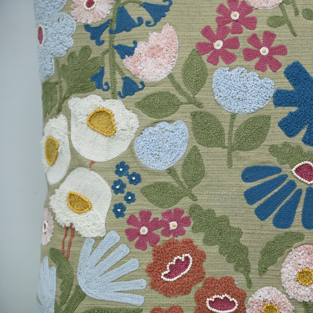 Floral patterned fabric with colorful flowers and leaves on a beige background