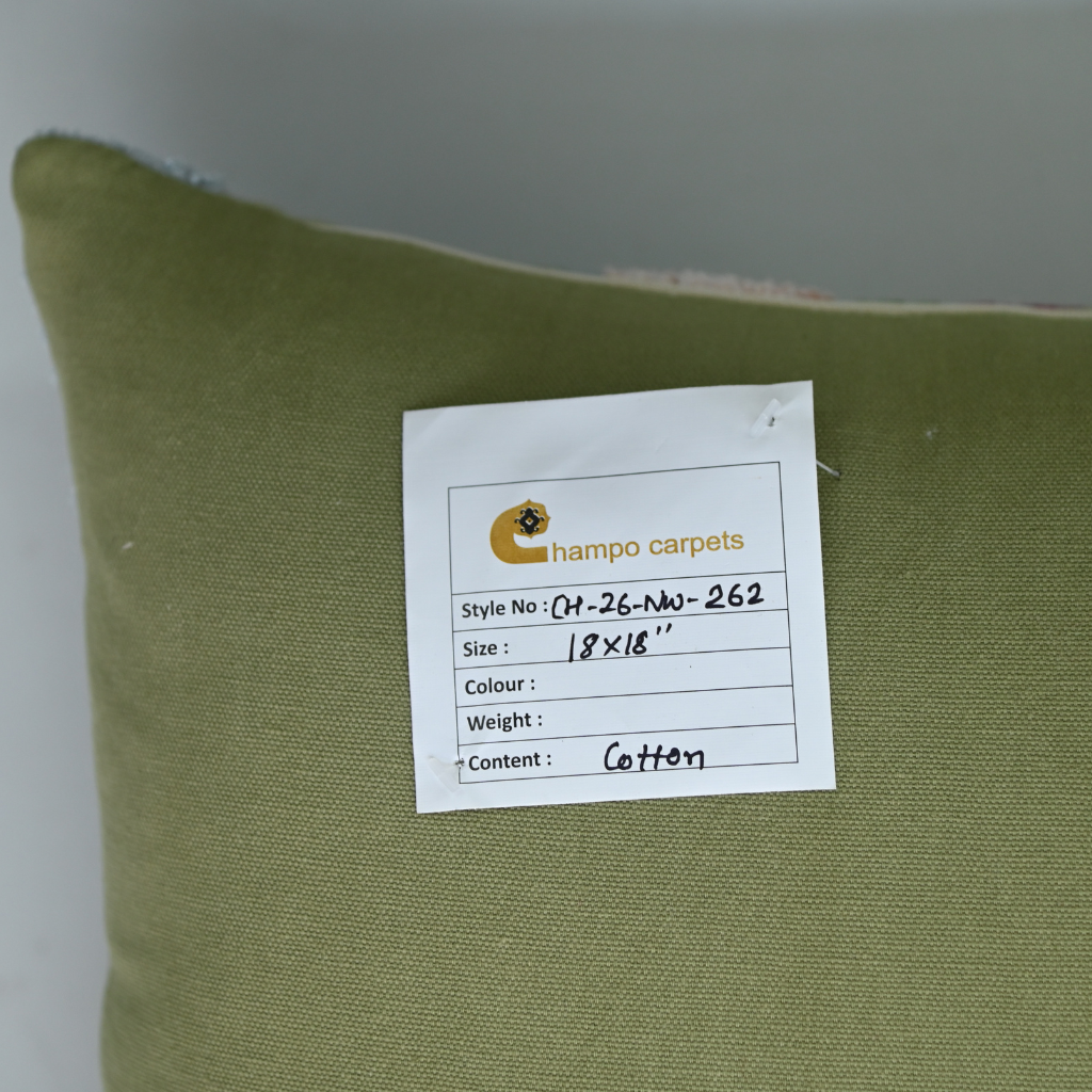 Green pillow with a label from Champo CarPets on a plain background