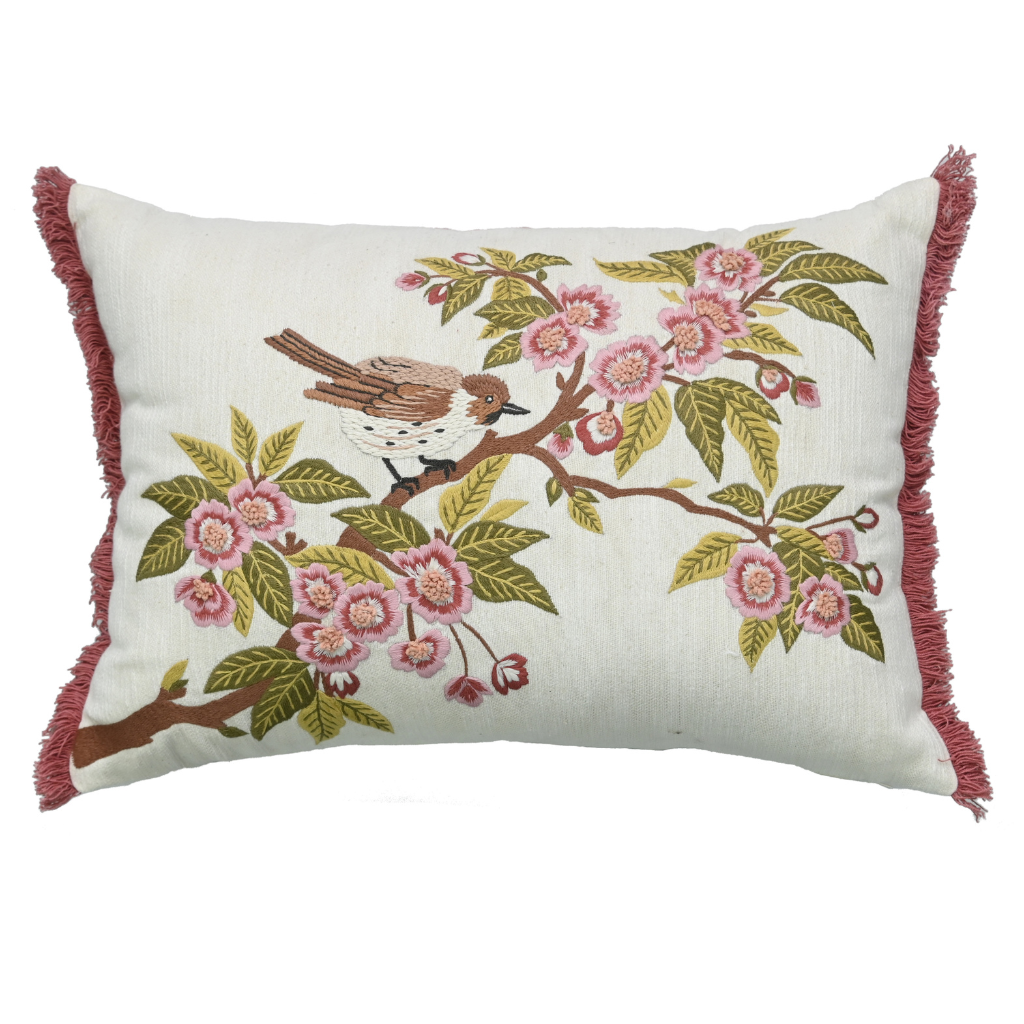 Decorative pillow with bird and floral design on a white background