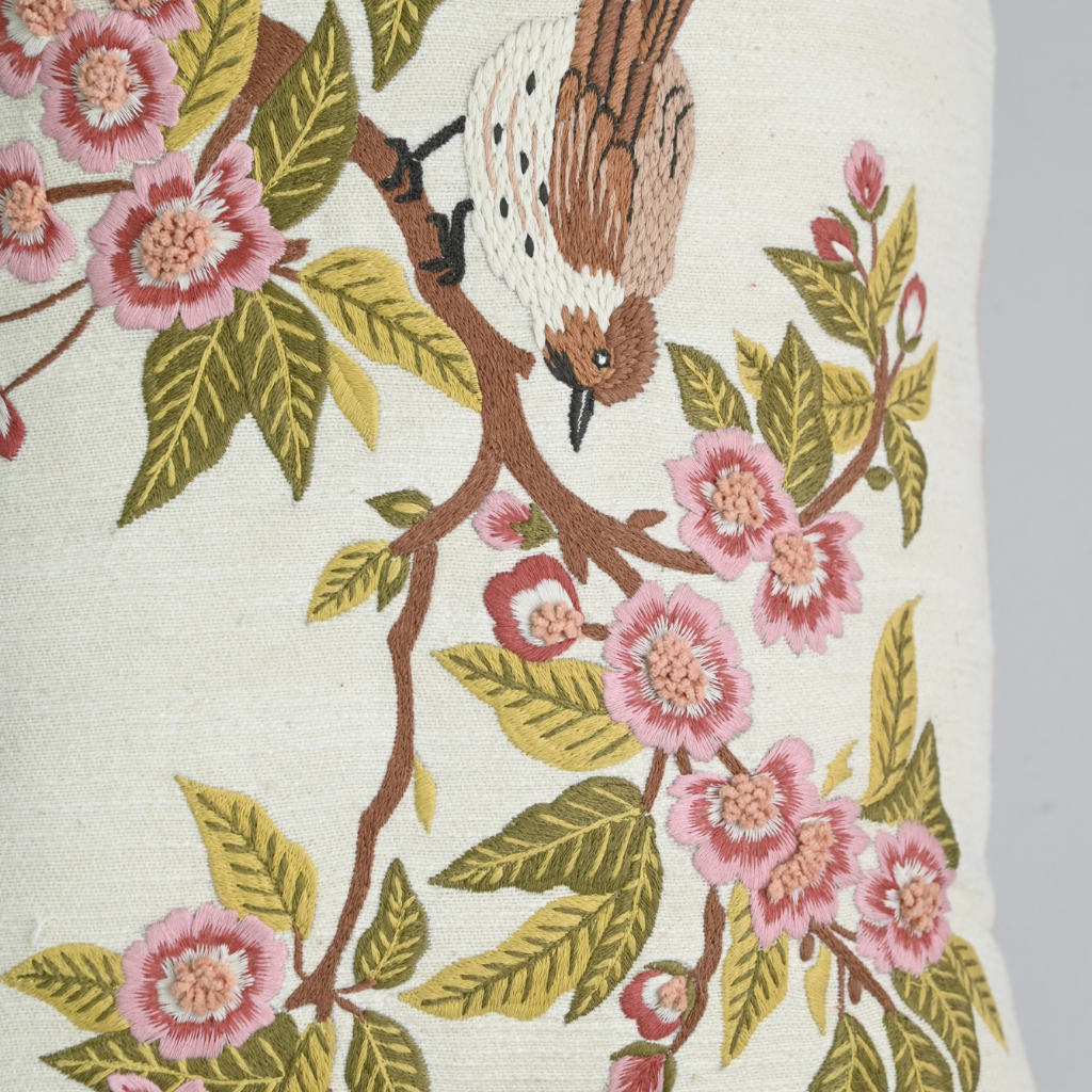 Embroidered fabric with birds and flowers on a branch