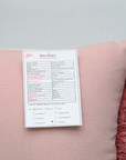 Pink fabric with a label on a gray background