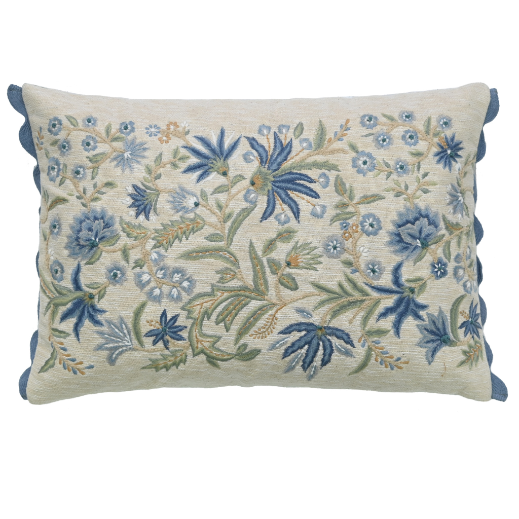 Decorative pillow with floral embroidery on a white background