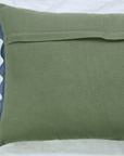 Green pillow with blue trim on a white background