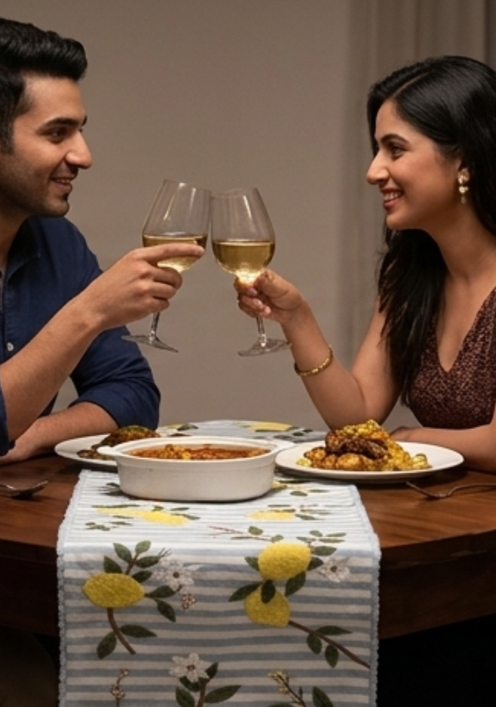 Man and woman toasting with wine glasses at a dinner table