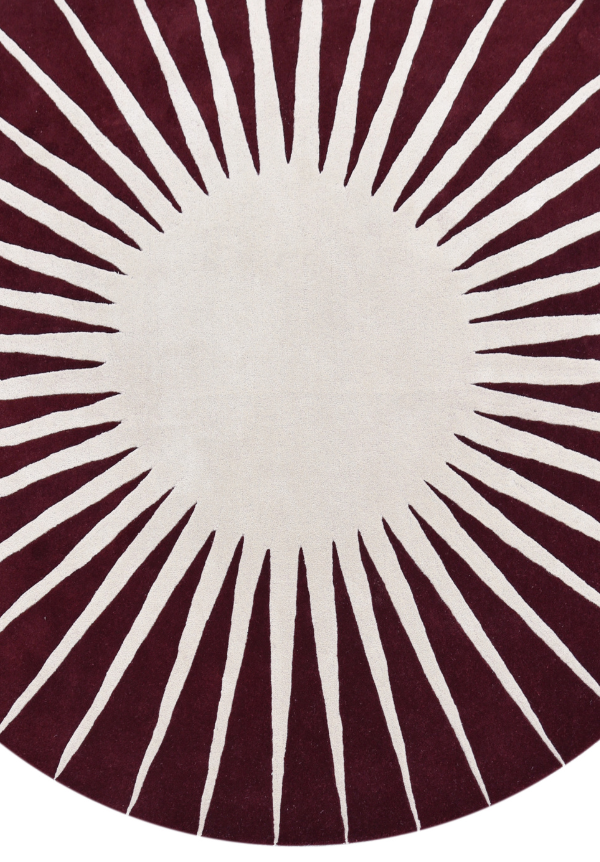 Close-up of Solara Ray handcrafted wool rug with radiating sunburst pattern