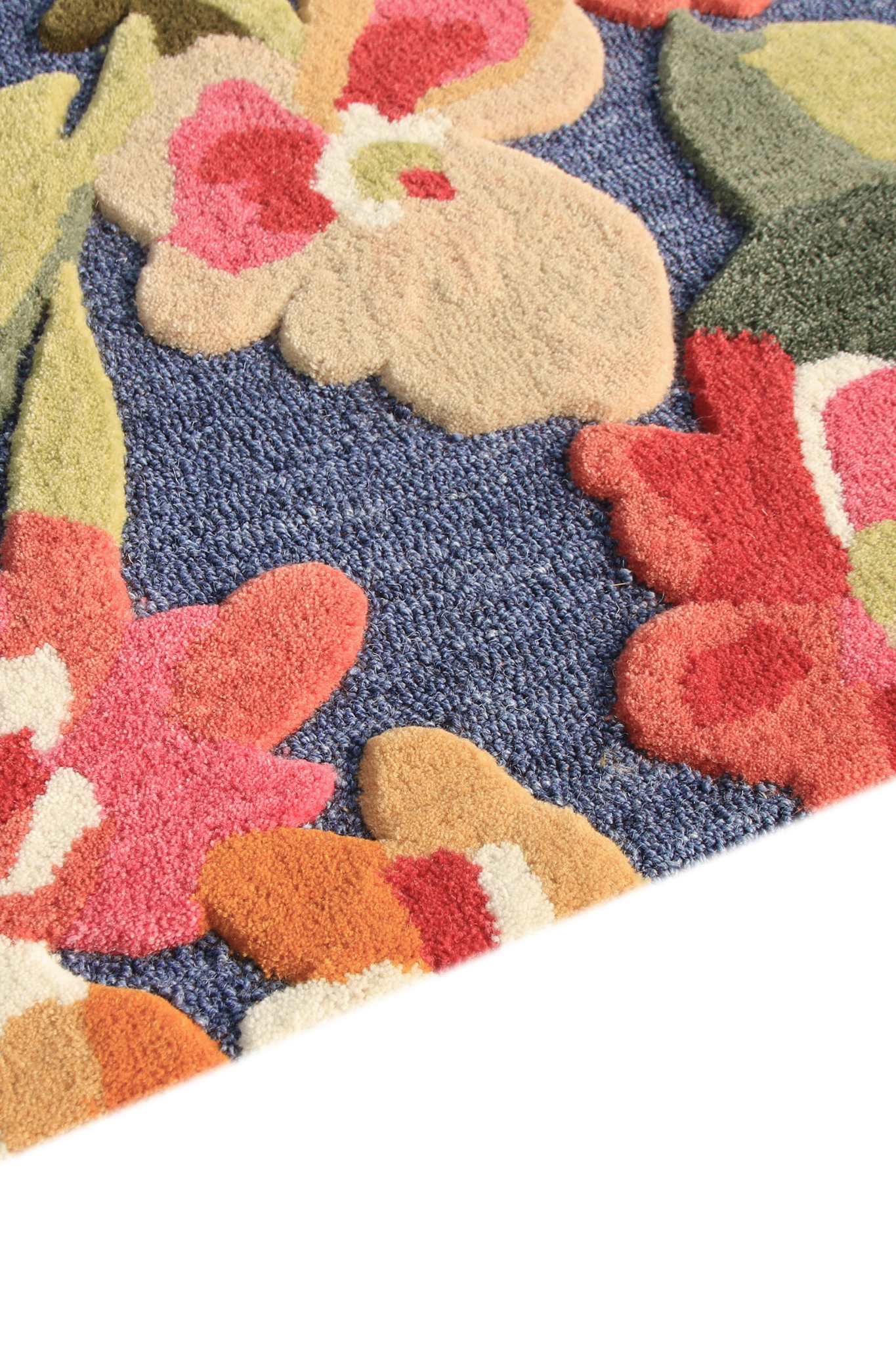 Close up carved rose petal detail hand tufted wool rug India